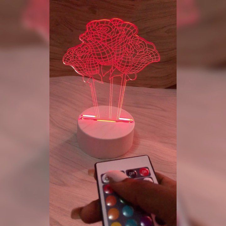 Make Table Lamp Ideas: 14 Designs in Wood, Glass and Ceramic 9 Rose-shaped acrylic table lamp glowing red with a remote control in foreground