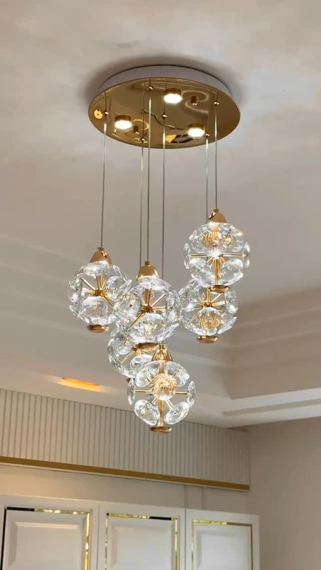 40 Home Decor Item Ideas, From Candle Holders to Sculptures 27 Gold ceiling light fixture with multiple hanging textured glass globe pendants.