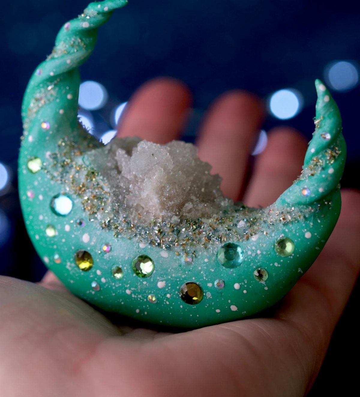 30 DIY Clay Crafts to Make with Air-Dry Clay for Home Decor 28 Teal clay crescent moon with a sparkling crystalline geode center and colorful rhinestones.