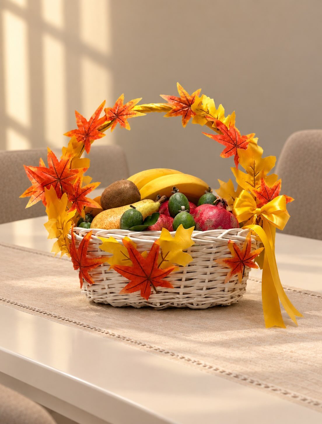 White wicker fruit basket decorated with autumn maple leaves and a yellow ribbon.