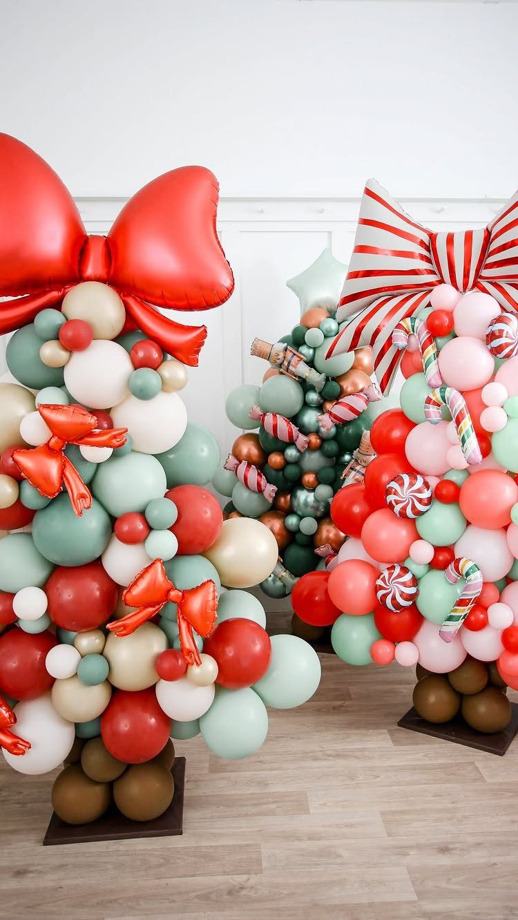 Balloon Christmas trees in red, green, and white with large red bows.