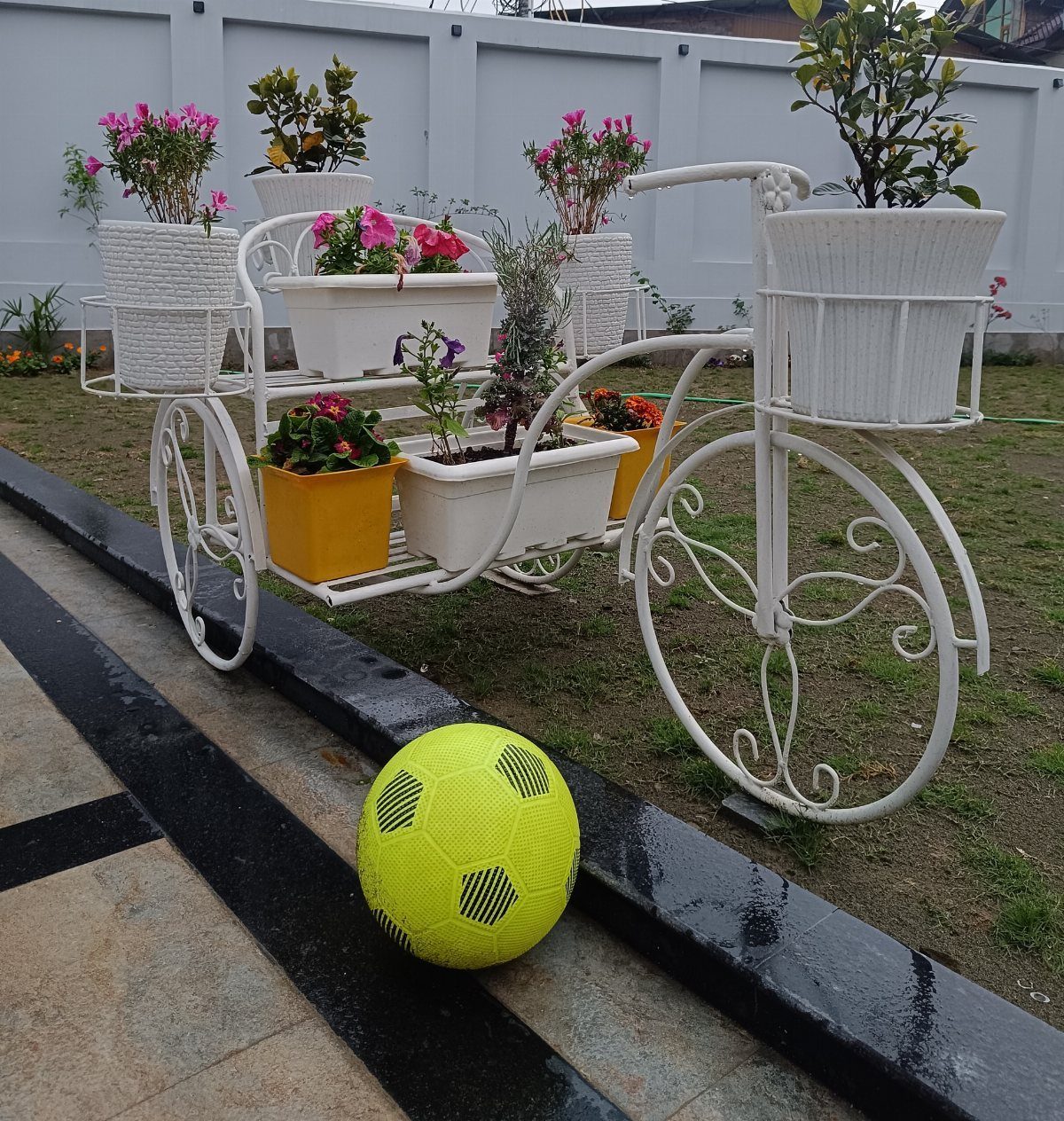 38 Flower Pot on Stand Ideas, from Iron Frames to Pedestals 32 White bicycle-shaped plant stand holding various flower pots on a grassy lawn.