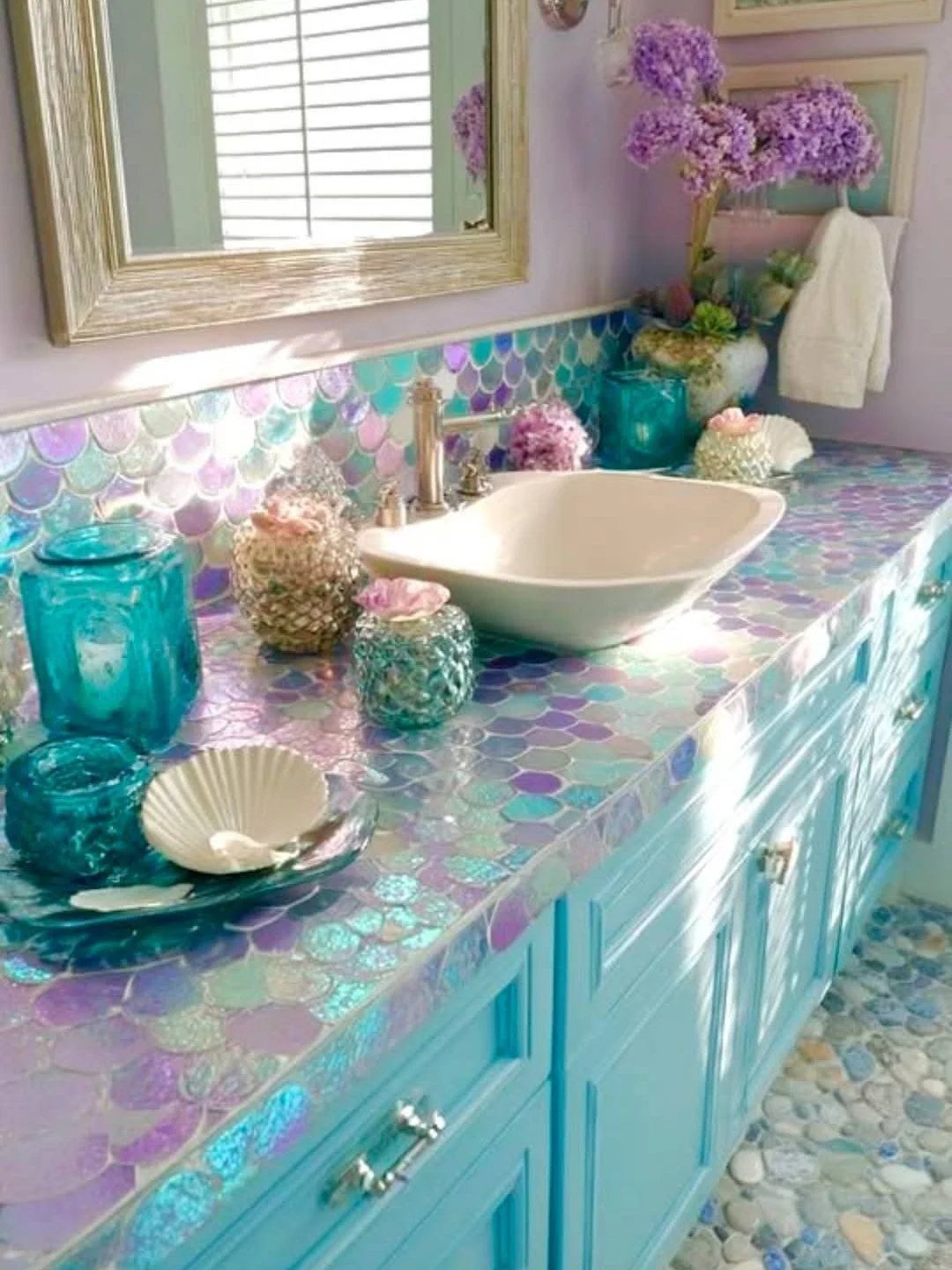 14 Home Decor Blue Ideas for Sofas, Walls, Kitchens and Baths 13 Iridescent blue scale tiles on a bathroom vanity with a white vessel sink.