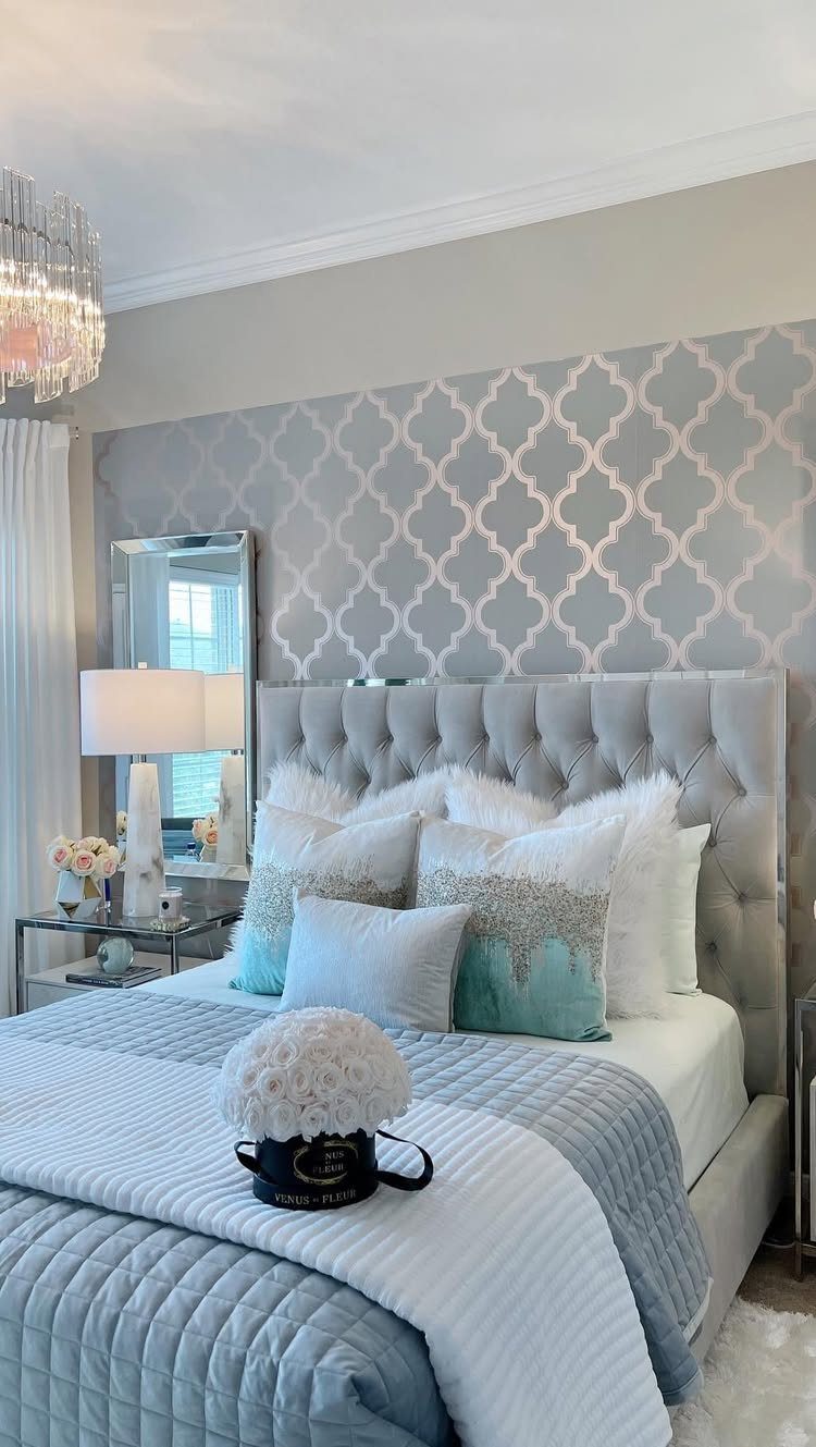 14 Home Decor Blue Ideas for Sofas, Walls, Kitchens and Baths 9 Light blue quilted bedding and pillows on a bed with a grey tufted headboard.