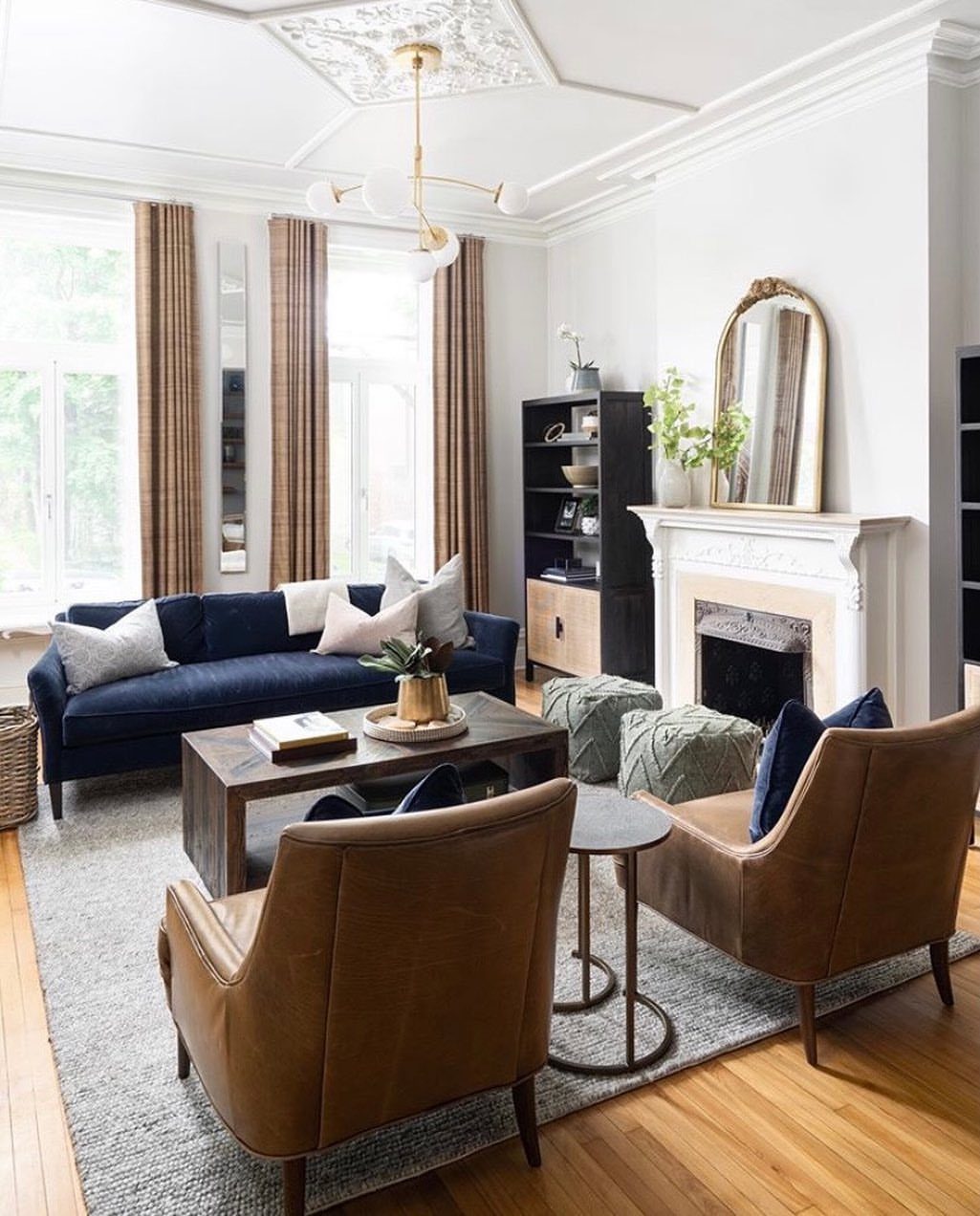 14 Home Decor Blue Ideas for Sofas, Walls, Kitchens and Baths 12 Navy blue sofa and brown leather armchairs in a bright living room with fireplace.