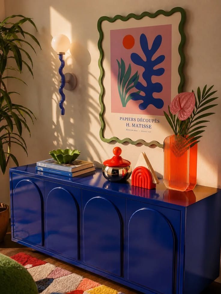 14 Home Decor Blue Ideas for Sofas, Walls, Kitchens and Baths 1 Blue glossy sideboard with arched doors and colorful decor against a white wall