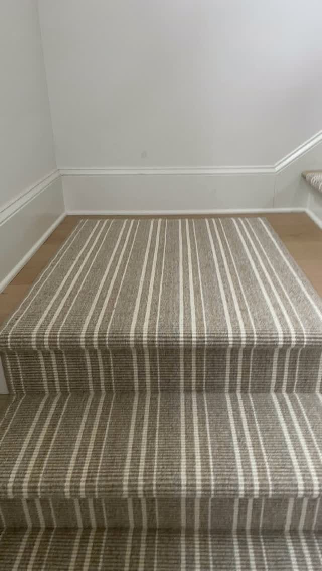 Stairs with Carpet: 23 Styles from Runners to Bold Patterns 2 Brown and cream striped carpet runner installed on a set of indoor stairs.
