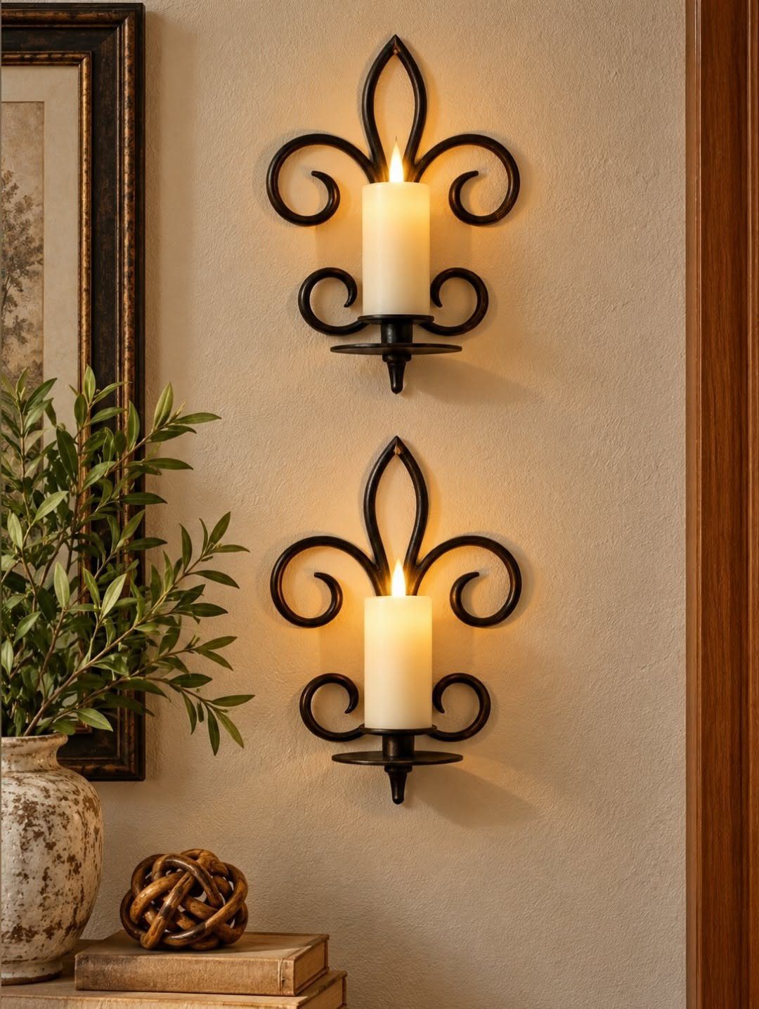 40 Home Decor Item Ideas, From Candle Holders to Sculptures 30 Black metal wall sconces with lit white pillar candles on a beige wall.