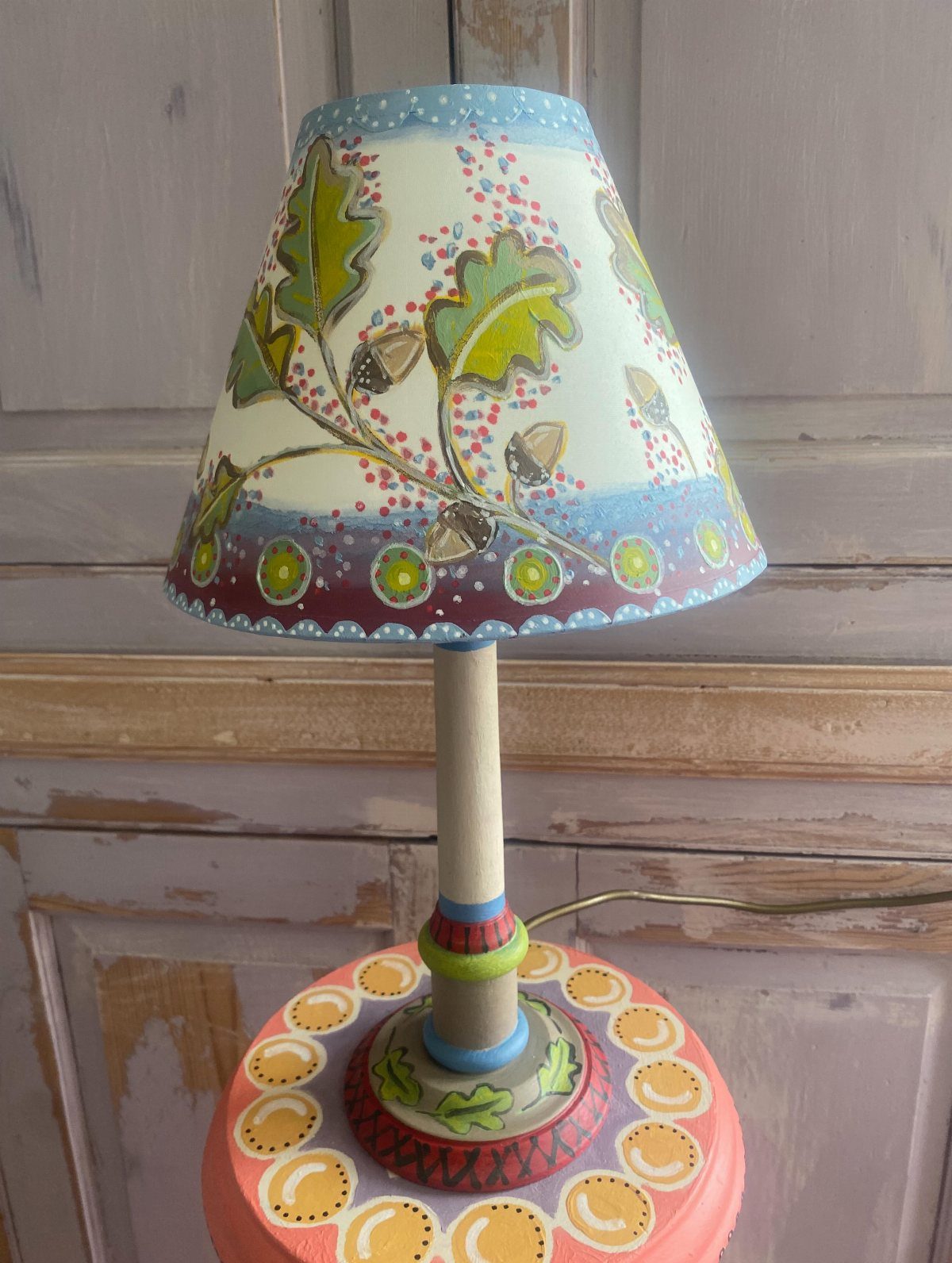 17 Handmade Lamps Ideas Using Wood, Concrete, and Glass Jars 11 Hand-painted table lamp with oak leaf shade and colorful patterned base.