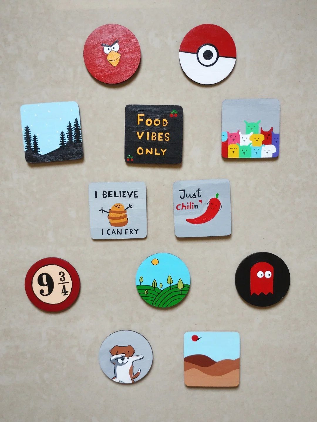 30 DIY Clay Crafts to Make with Air-Dry Clay for Home Decor 4 Small hand-painted clay magnets in various shapes and colorful designs on a plain background.