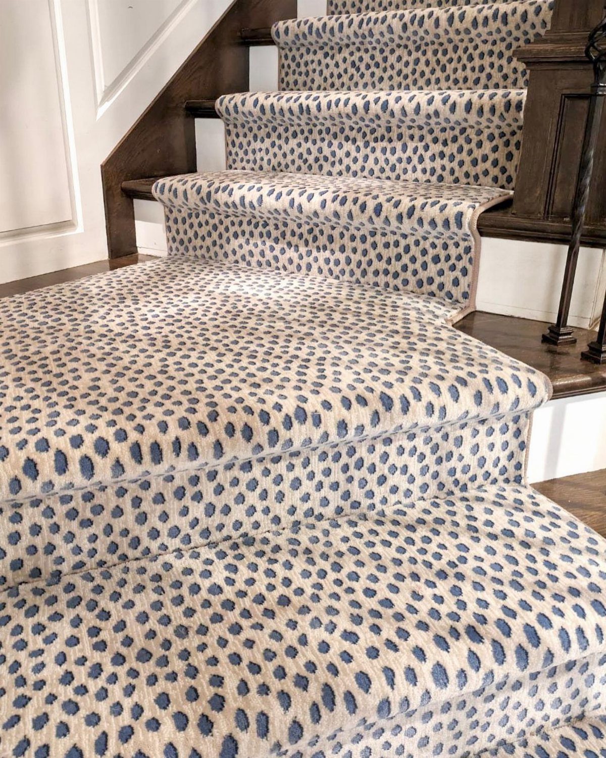Stairs with Carpet: 23 Styles from Runners to Bold Patterns 8 Patterned blue and cream carpet runner on wooden stairs with dark brown railings