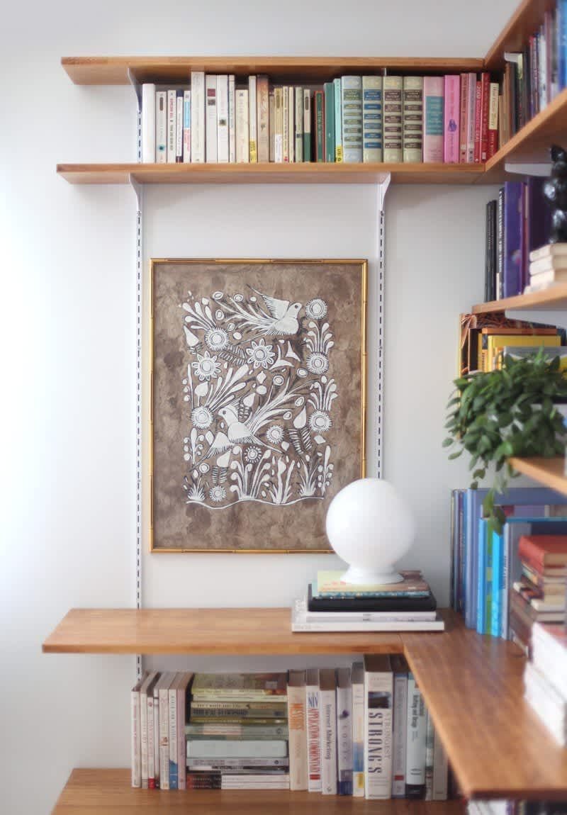 24 Corner Shelves IKEA Ideas for Kitchens, TVs and Plants 11 Wooden corner shelves supported by white metal brackets holding books and art.