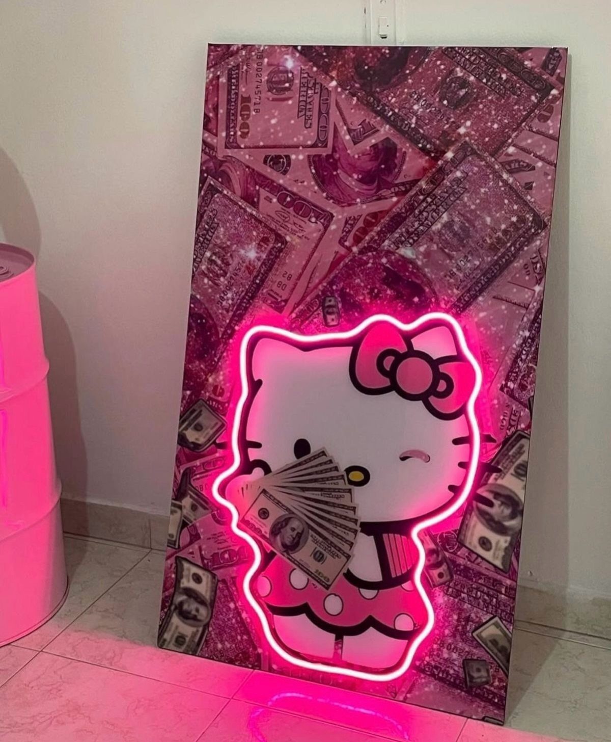 Pink neon Hello Kitty sign holding money against a dollar bill background.