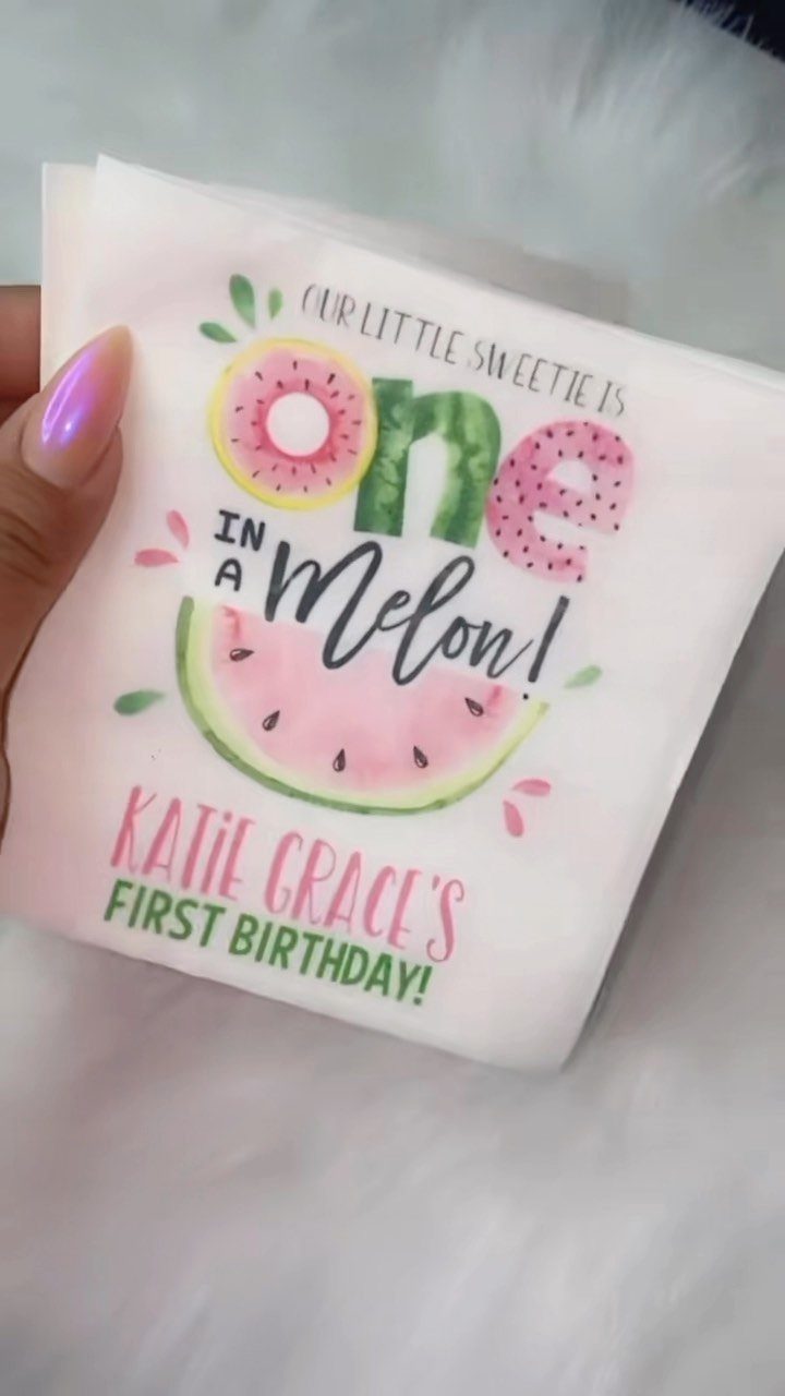 White paper napkin with watermelon graphics and personalized first birthday text.