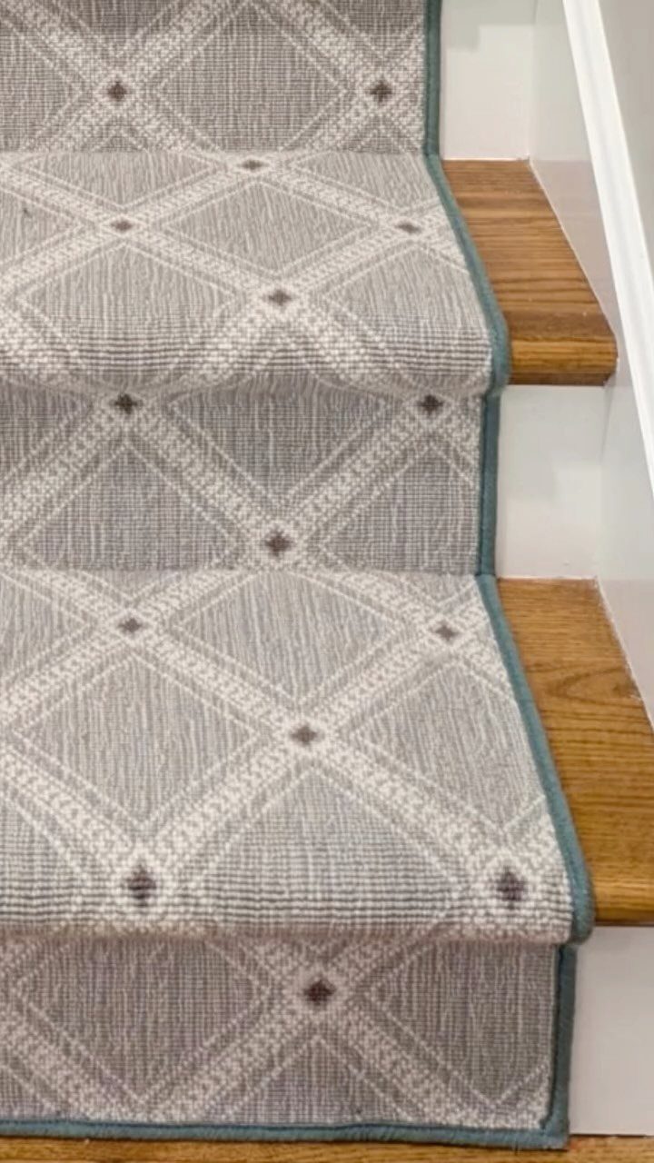 Stairs with Carpet: 23 Styles from Runners to Bold Patterns 18 Grey and white diamond patterned carpet runner on wooden stairs with blue edging.