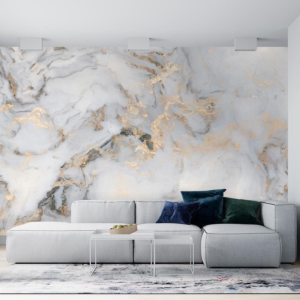 23 Cool House Items for Walls, Shelves, Desks, and Baths 5 Marble-patterned wallpaper with gold veins on a living room wall behind a grey sofa.