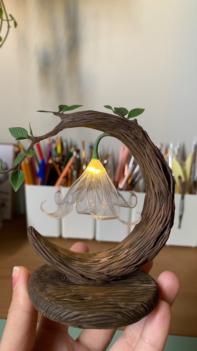 Make Table Lamp Ideas: 14 Designs in Wood, Glass and Ceramic 1 Figurine table lamp with a curved wooden branch and glowing flower bulb.
