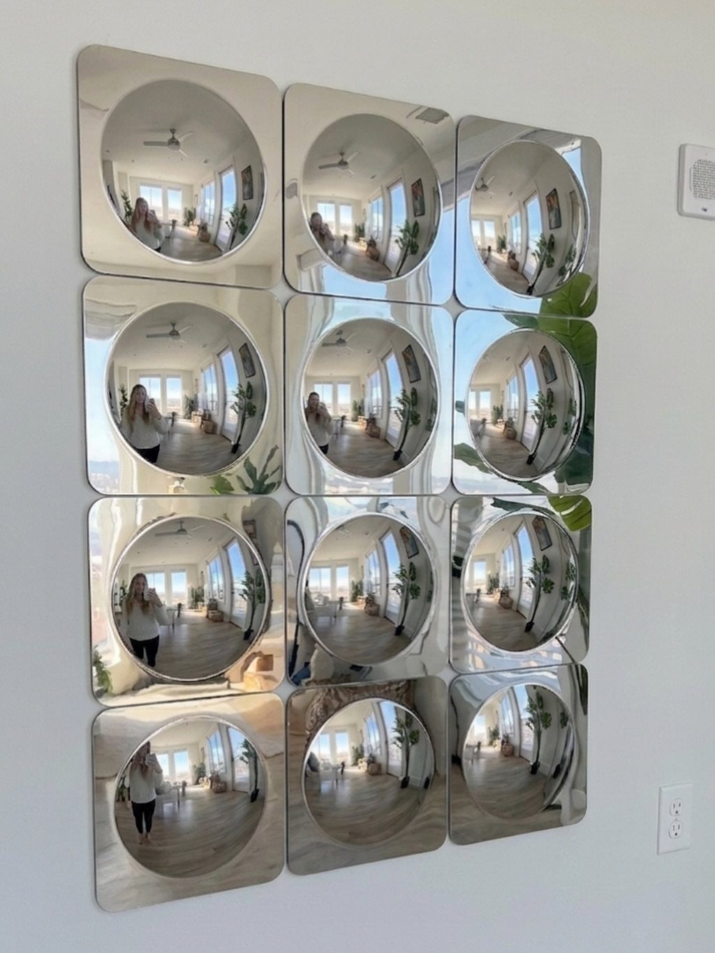 Mirror Wall Art: 25 Ideas from Sunburst to Floor Mirrors 19 Grid of twelve square convex mirrors reflecting a bright interior room on white wall