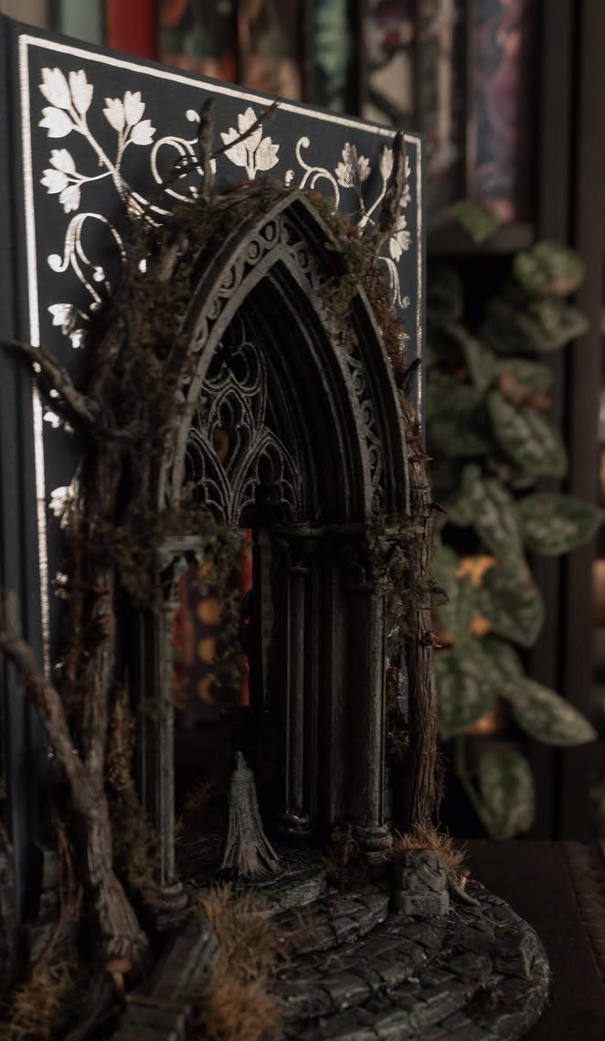 Gothic miniature book nook diorama with a dark stone archway and overgrown vines.