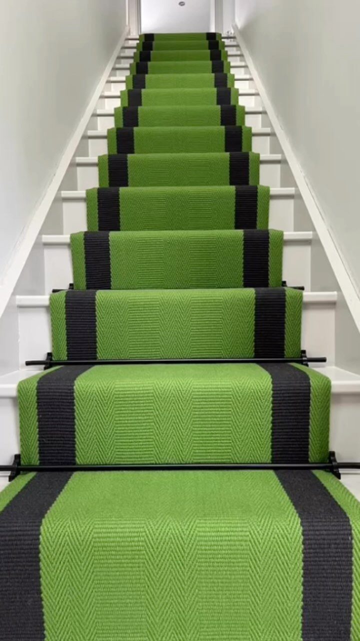 Stairs with Carpet: 23 Styles from Runners to Bold Patterns 7 Green carpet runner with black stripes on white wooden stairs with black rods.