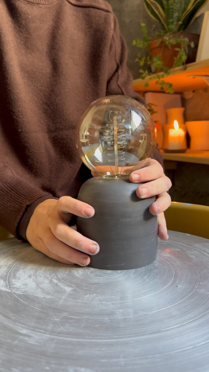Make Table Lamp Ideas: 14 Designs in Wood, Glass and Ceramic 13 Handmade table lamp with a black ceramic base and large glass bulb.