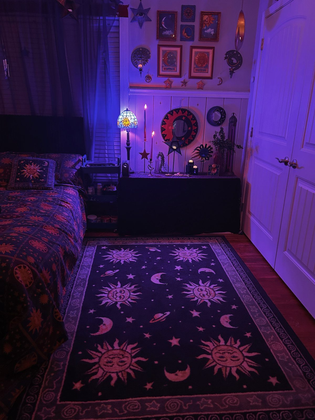 13 Alt Room Decor Ideas with Moody Colors, Wood, and Plants 10 Celestial themed bedroom with purple lighting, sun and moon rug, and cosmic wall art.