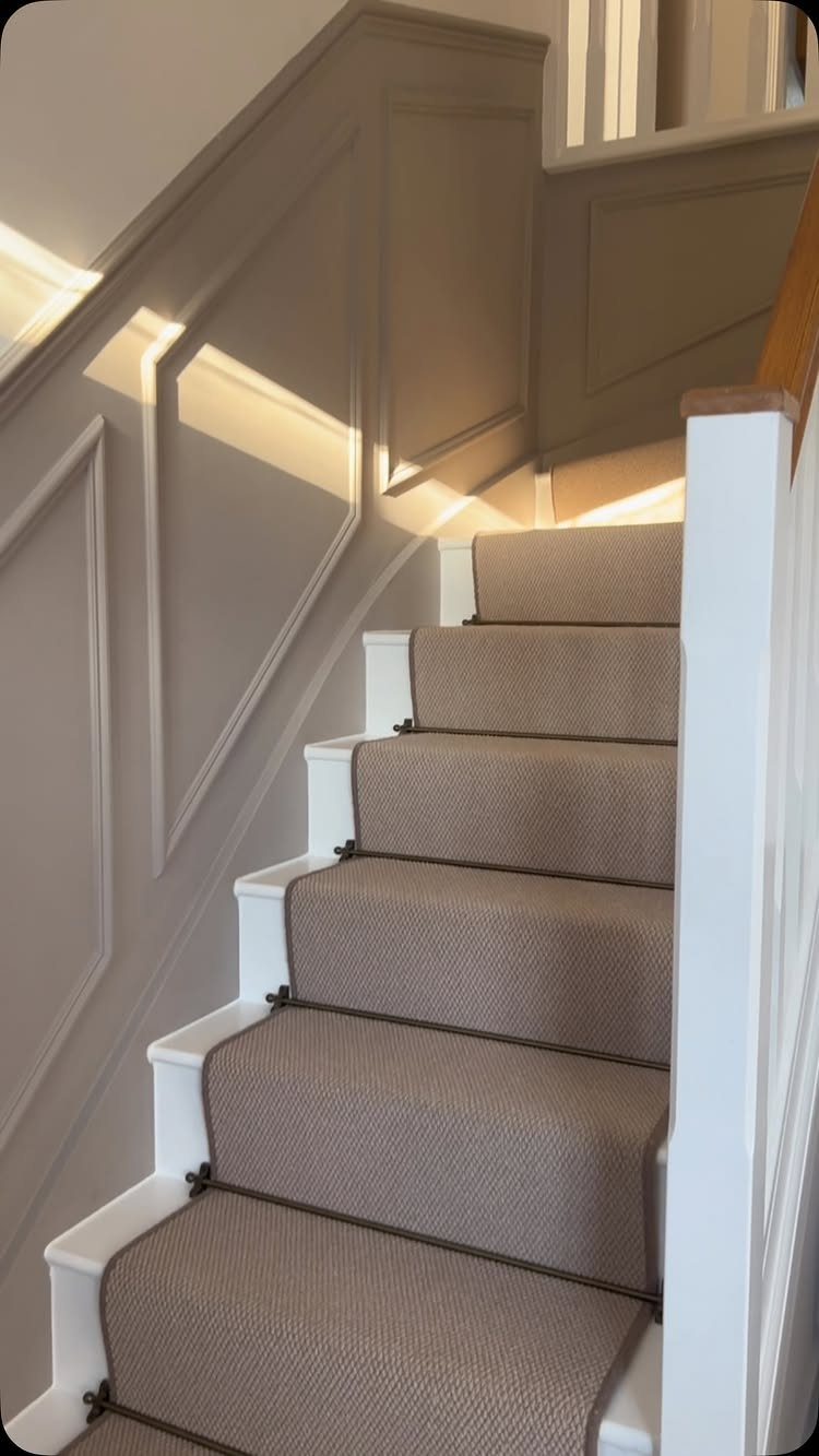 Stairs with Carpet: 23 Styles from Runners to Bold Patterns 4 Beige textured carpet on stairs with white risers and grey paneled walls.
