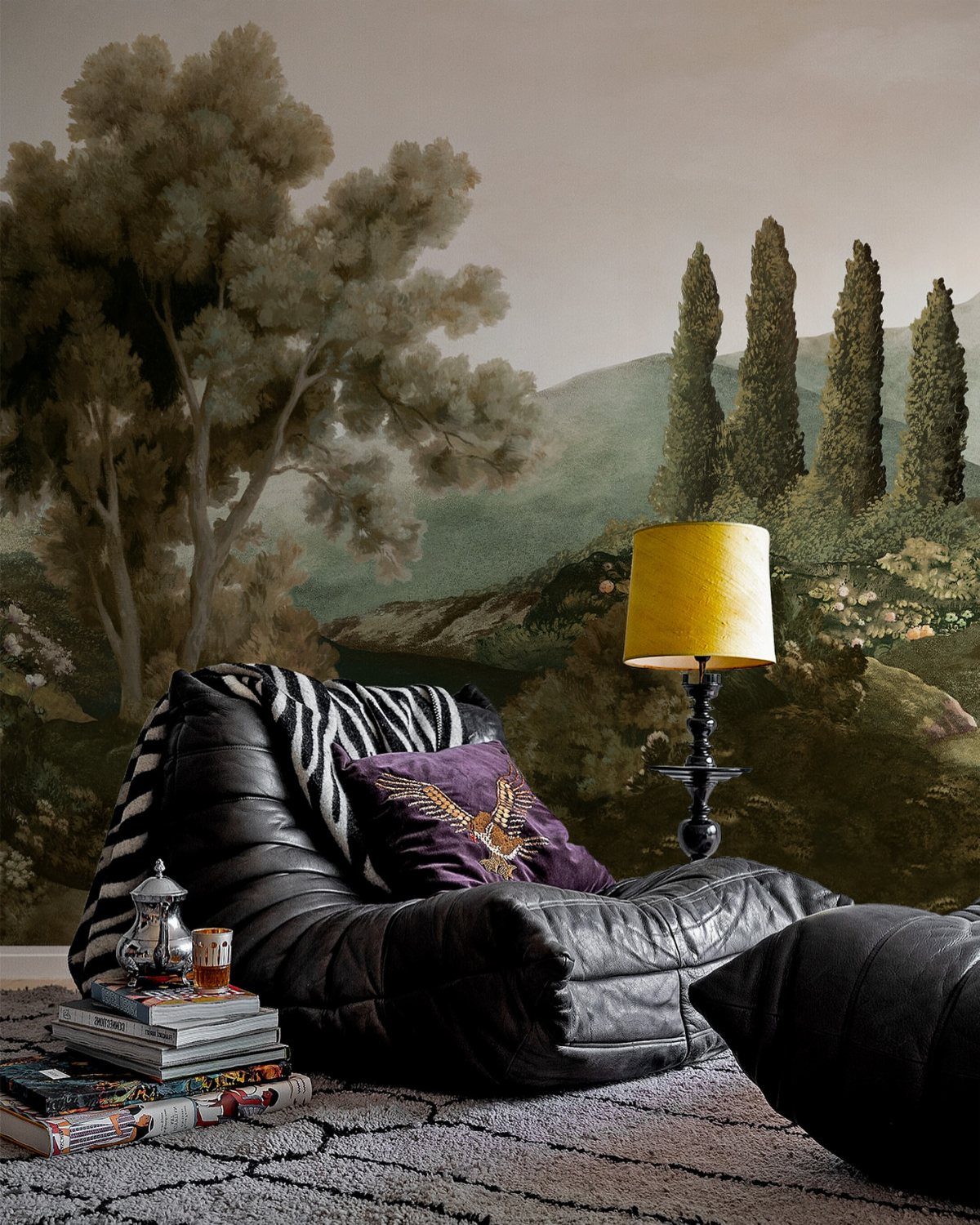 Eclectic room with a landscape mural, black leather chair, and yellow lamp.