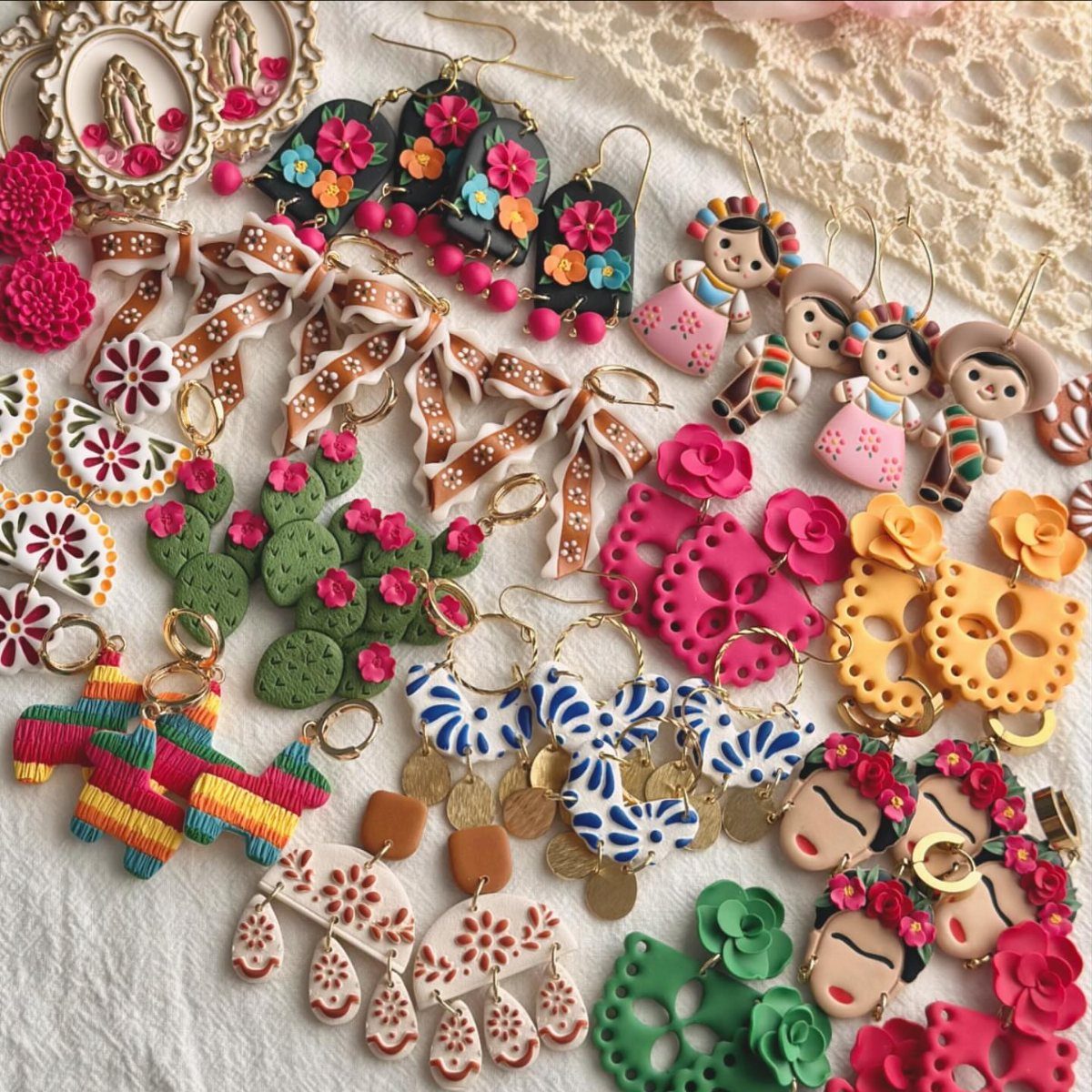 30 DIY Clay Crafts to Make with Air-Dry Clay for Home Decor 11 Colorful handmade polymer clay earrings with floral and cultural designs on a white background.
