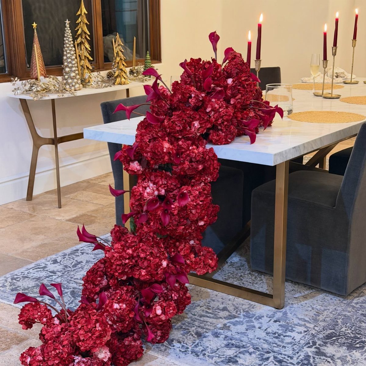 34 Large Floral Arrangement Ideas for Tables, Trays and Vases 9 Cascading red hydrangea and calla lily arrangement flowing from a white marble table.