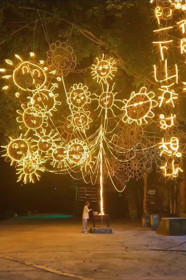 13 Rope Lighting Ideas Outdoor for Decks, Steps and Fences 13 Glowing yellow rope lights shaped like suns and flowers on an outdoor tree