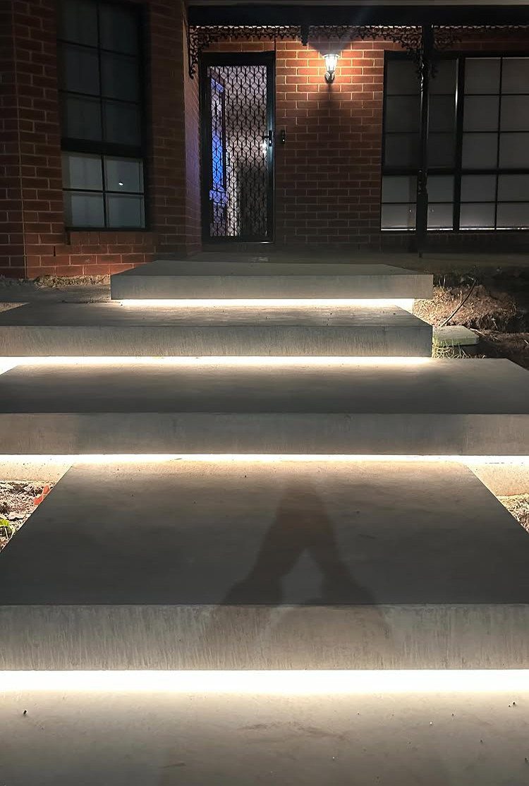 13 Rope Lighting Ideas Outdoor for Decks, Steps and Fences 11 Concrete outdoor steps with warm white rope lighting installed under each step ledge.