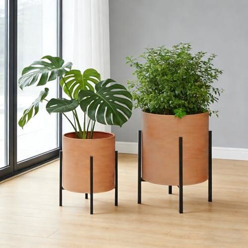 38 Flower Pot on Stand Ideas, from Iron Frames to Pedestals 26 Two terracotta planters in black metal frame stands on a light wooden floor.