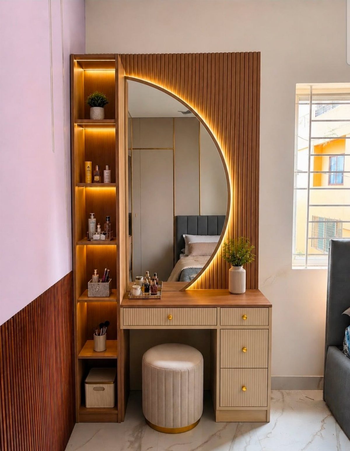 12 Small Bedroom Mirror Ideas That Make a Room Feel Bigger 10 Round backlit mirror on a wooden vanity desk with a small cream ottoman.