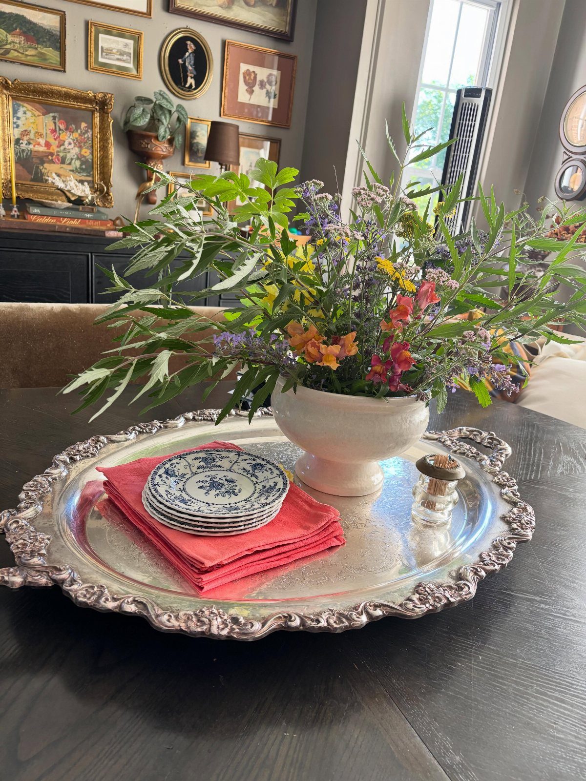34 Large Floral Arrangement Ideas for Tables, Trays and Vases 4 Colorful floral arrangement in a white bowl on a silver tray with plates.