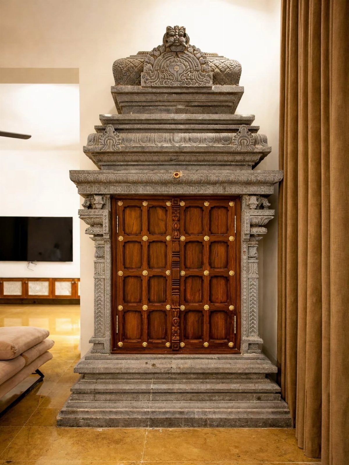 34 Puja Unit Design Modern Ideas for Your Home in 2026 7 Stone-carved mandir with wooden doors and a tiered grey stone roof in a home.
