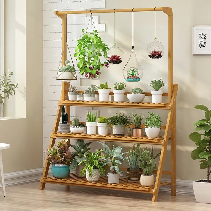 House Plant Pots: 21 Ideas in Ceramic, Terracotta and Metal 13 Wooden tiered plant stand with various potted houseplants and hanging glass terrariums.