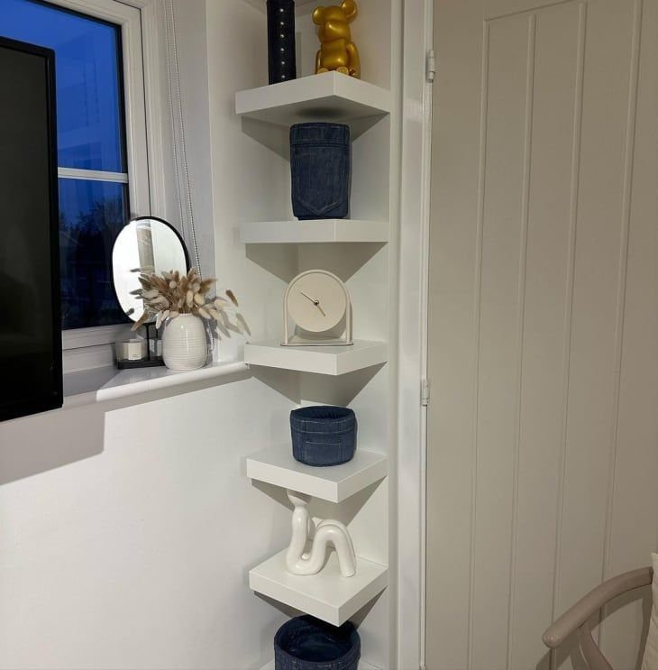 24 Corner Shelves IKEA Ideas for Kitchens, TVs and Plants 19 White triangular corner shelves holding decorative vases and a gold bear on a wall.