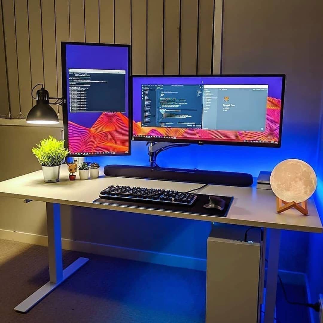 13 Double Monitor Desk Setup Aesthetic Ideas That Work 4 Ultrawide monitor paired with a vertical monitor on a white desk with blue lighting.