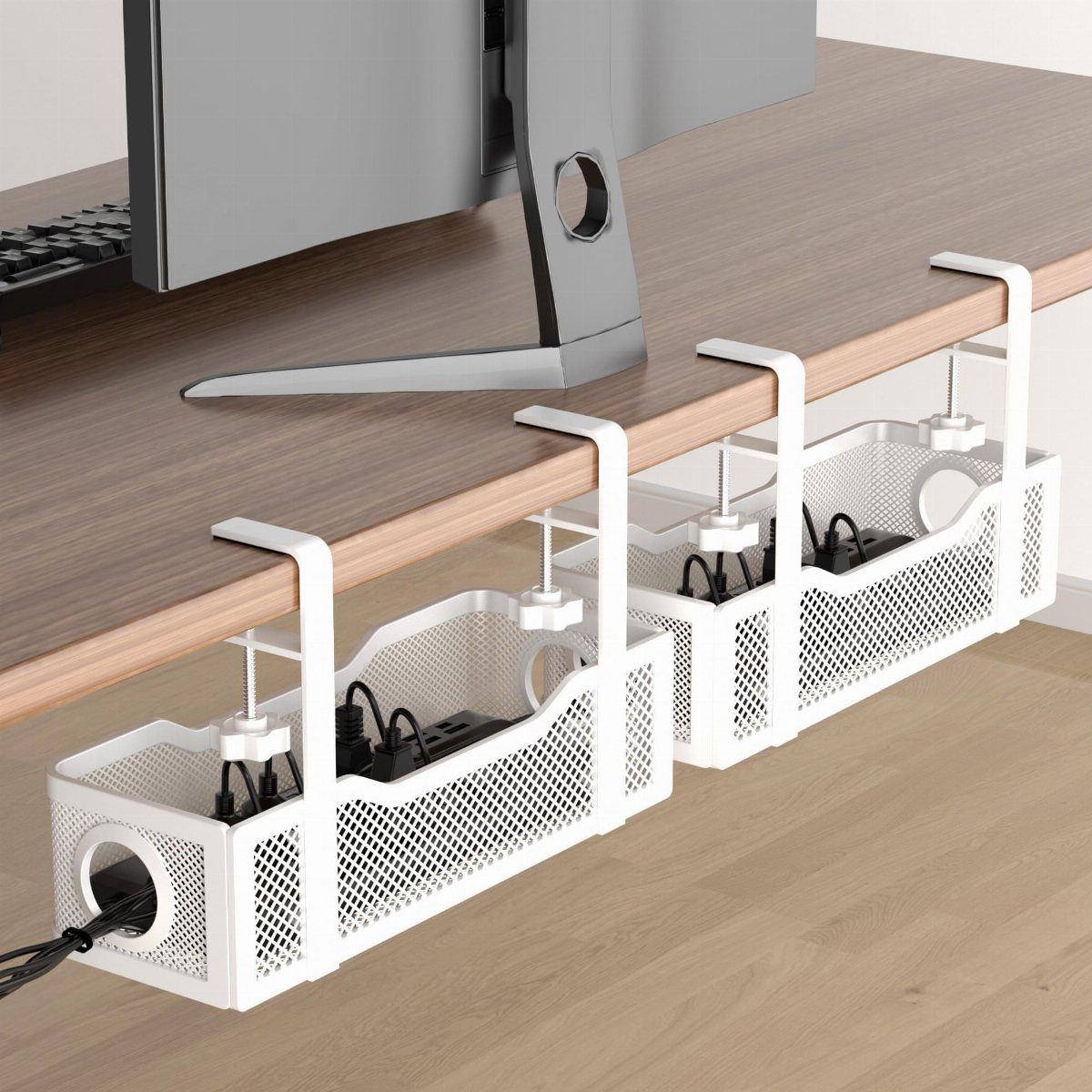 White mesh under-desk trays holding power strips and cables beneath a wooden desk