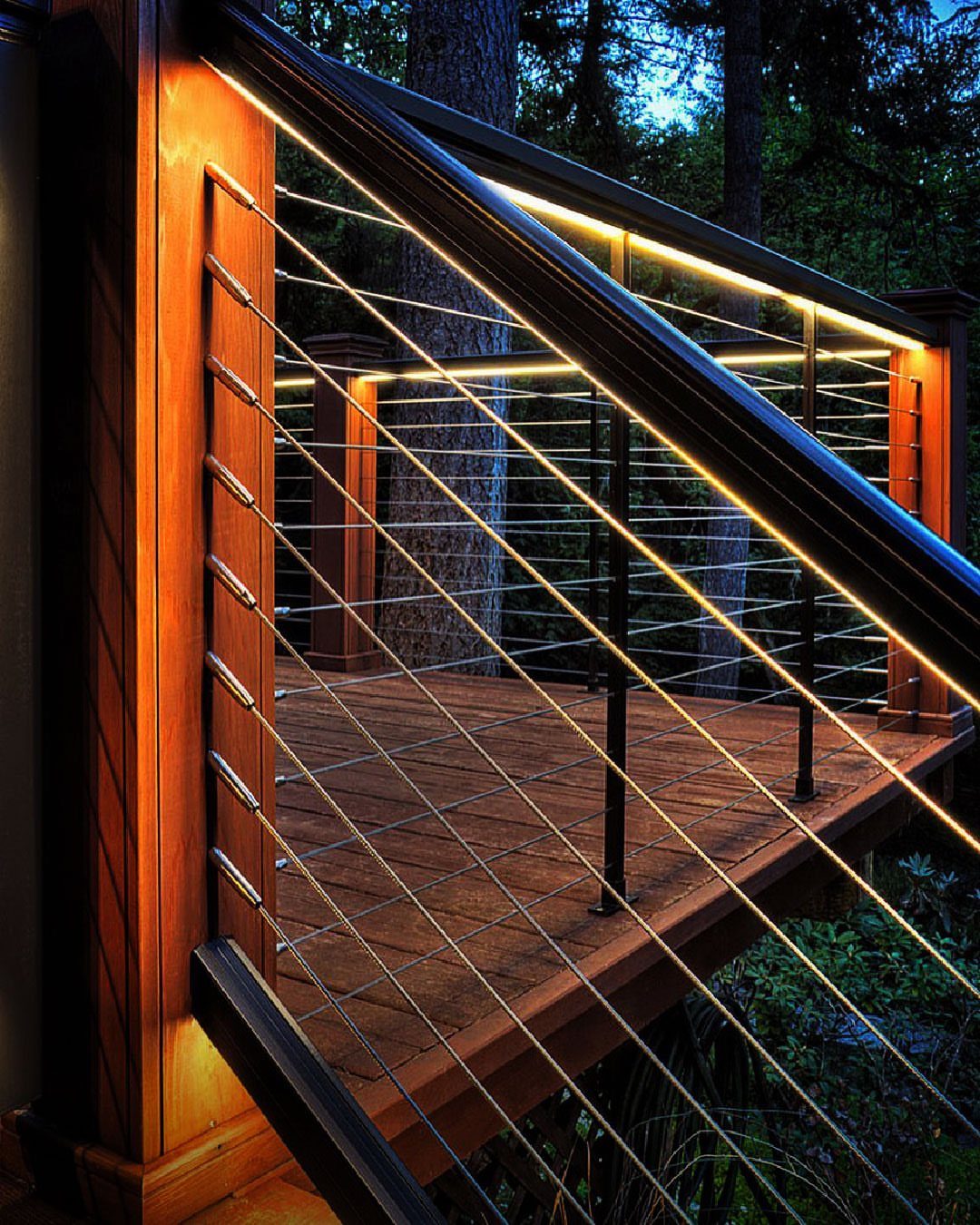 13 Rope Lighting Ideas Outdoor for Decks, Steps and Fences 2 Wooden deck with warm rope lighting installed under the black metal handrails