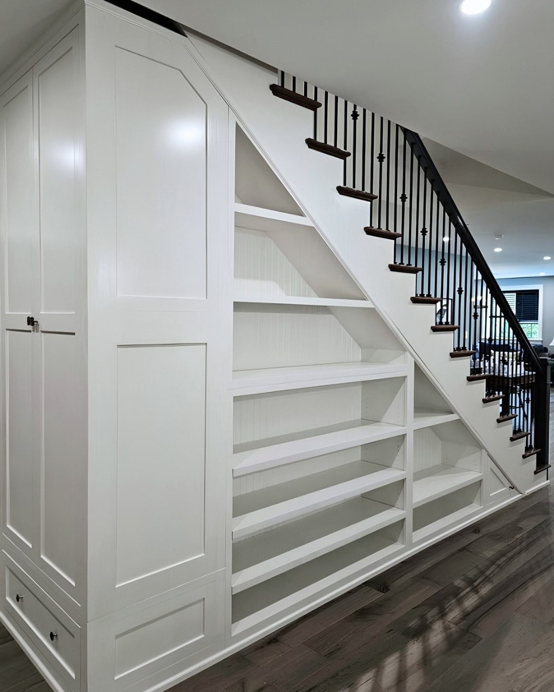 12 Ideas for Book Storage From Floating Shelves to Side Tables 6 White built-in shelving units installed in the space beneath a residential staircase.