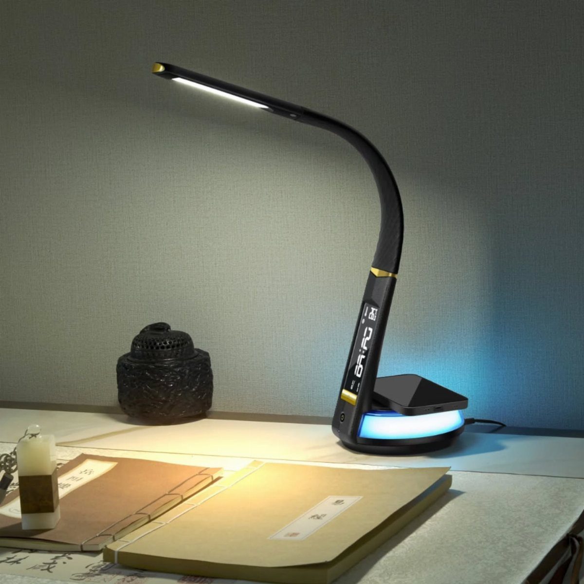 Curved black LED desk lamp illuminating a notebook and papers on a desk