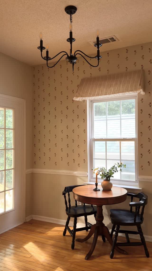 Striped fabric valance covering the top of a window in a dining nook.