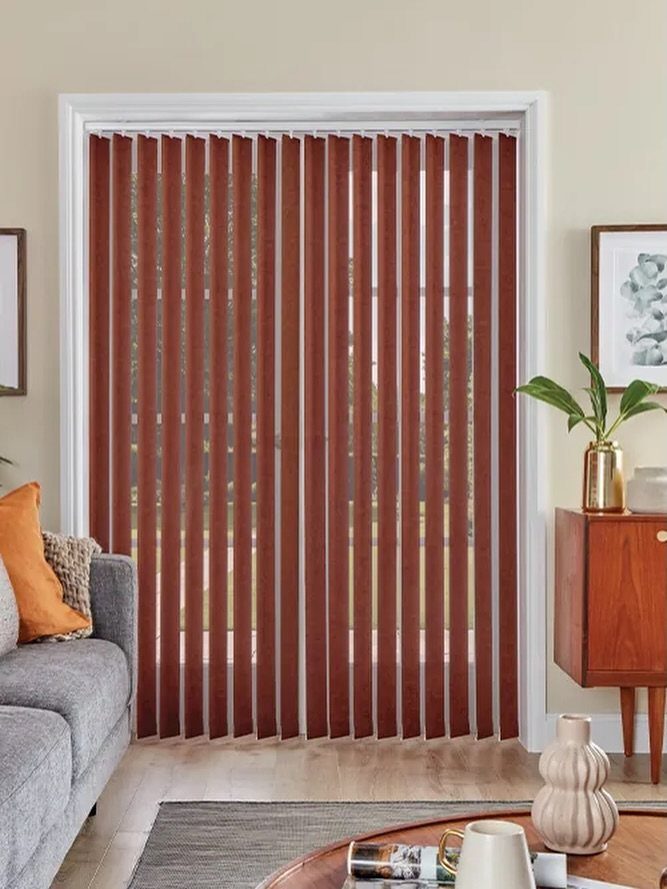 Reddish-brown vertical blinds covering a large window in a modern living room.