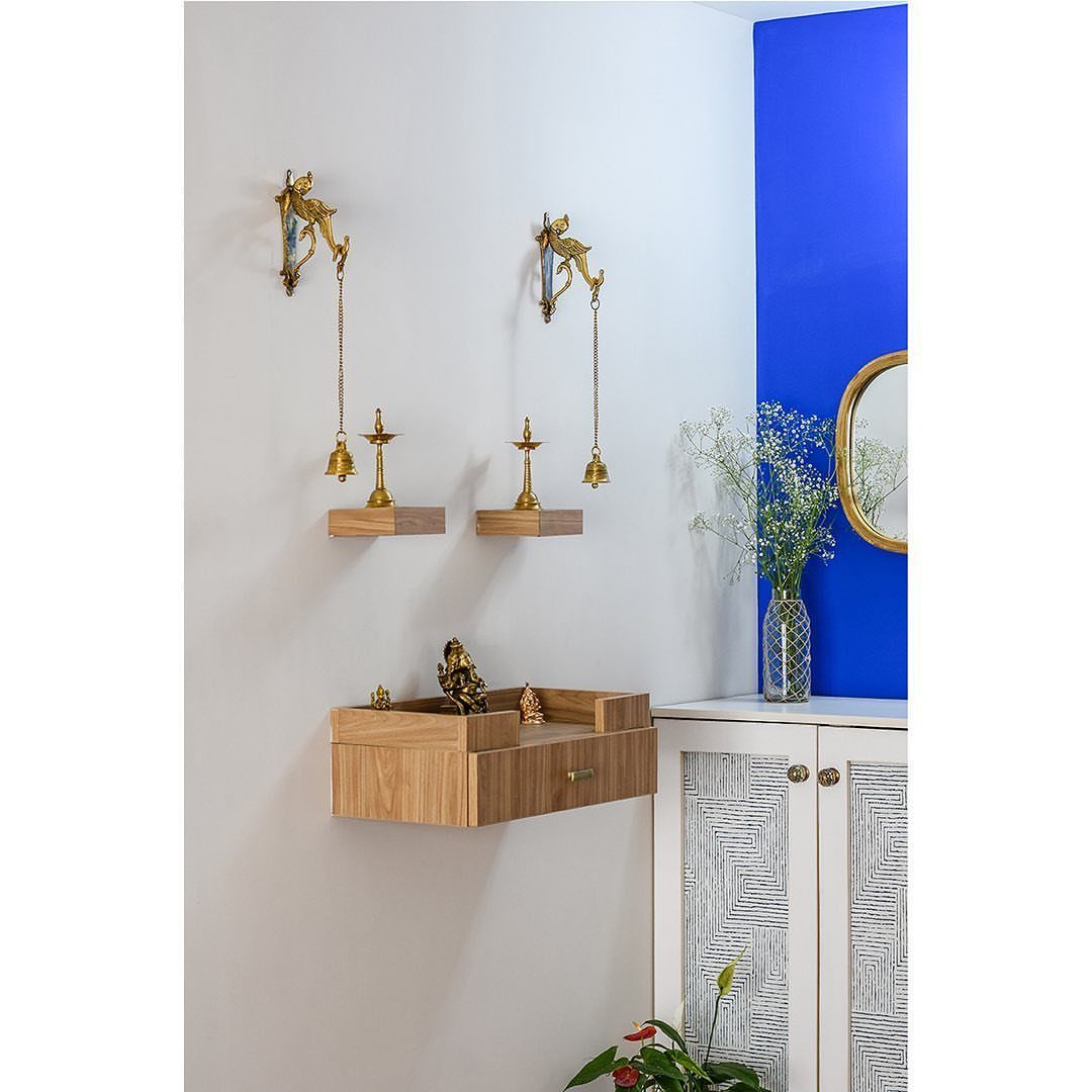 34 Puja Unit Design Modern Ideas for Your Home in 2026 23 Wall-mounted wooden puja unit with Ganesha idol and brass bells on white wall
