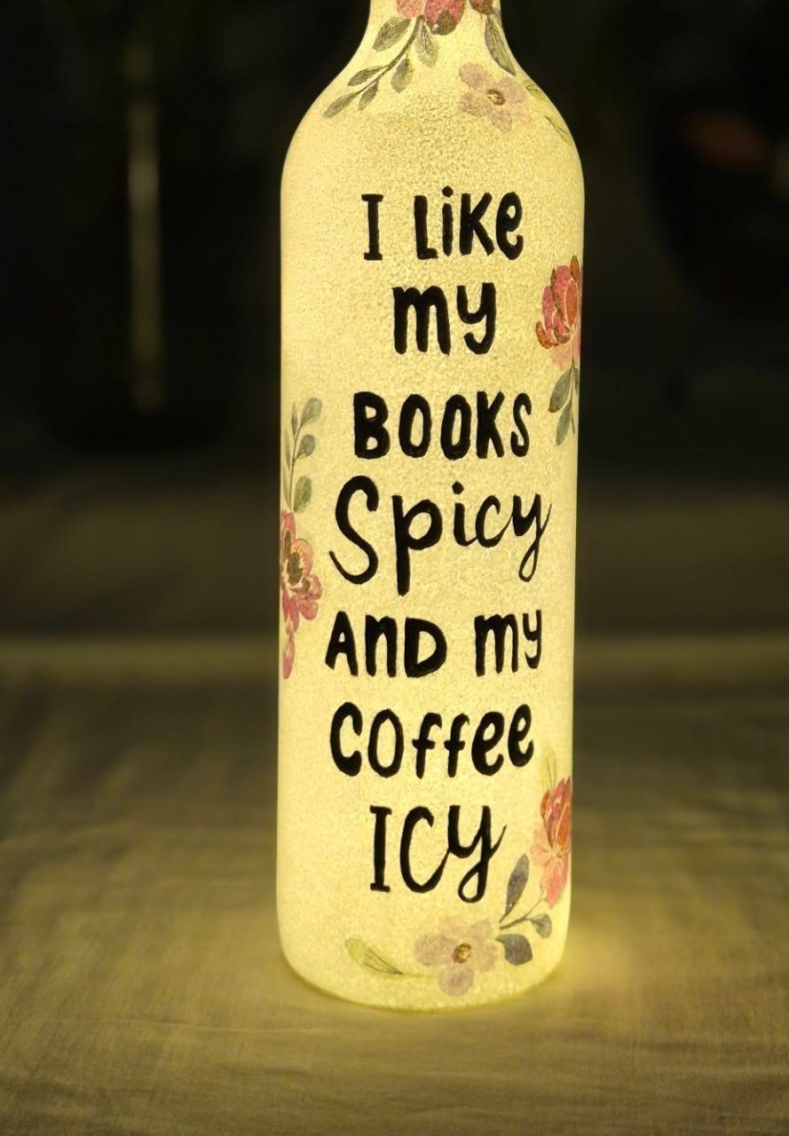 17 Handmade Lamps Ideas Using Wood, Concrete, and Glass Jars 8 Frosted wine bottle lamp with floral designs and a quote about books and coffee.
