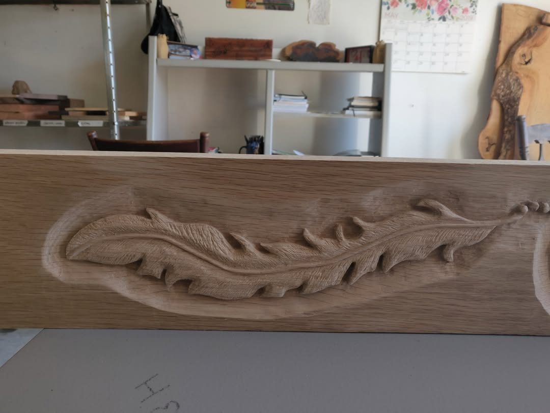 Wood Art Wall Decor: 28 Ideas, From Carved Panels to Mirrors 19 Carved botanical leaf design recessed into a light-colored wooden wall panel.