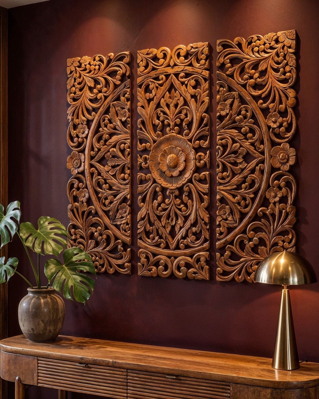 Wood Art Wall Decor: 28 Ideas, From Carved Panels to Mirrors 8 Three carved wooden wall panels with floral patterns on a dark red wall.